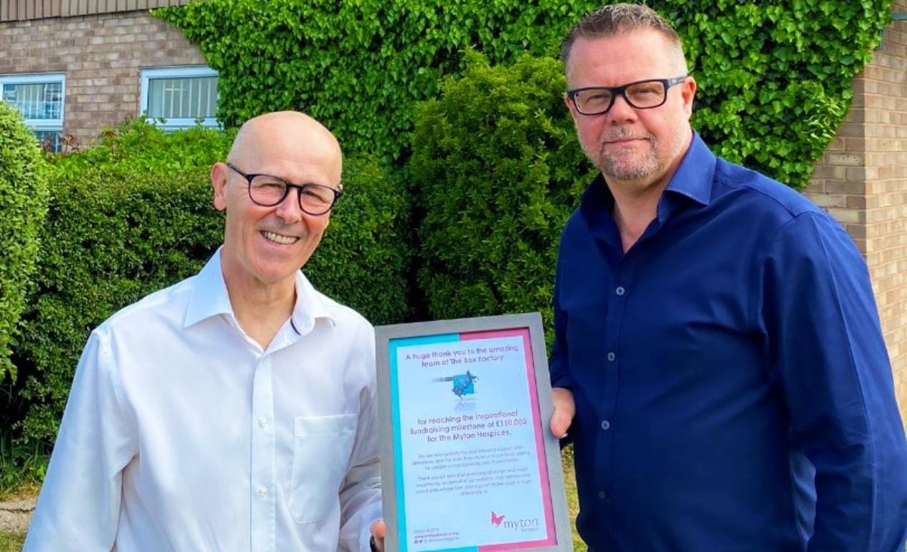 Neil and Phil from The Box Factory holding a framed thank you