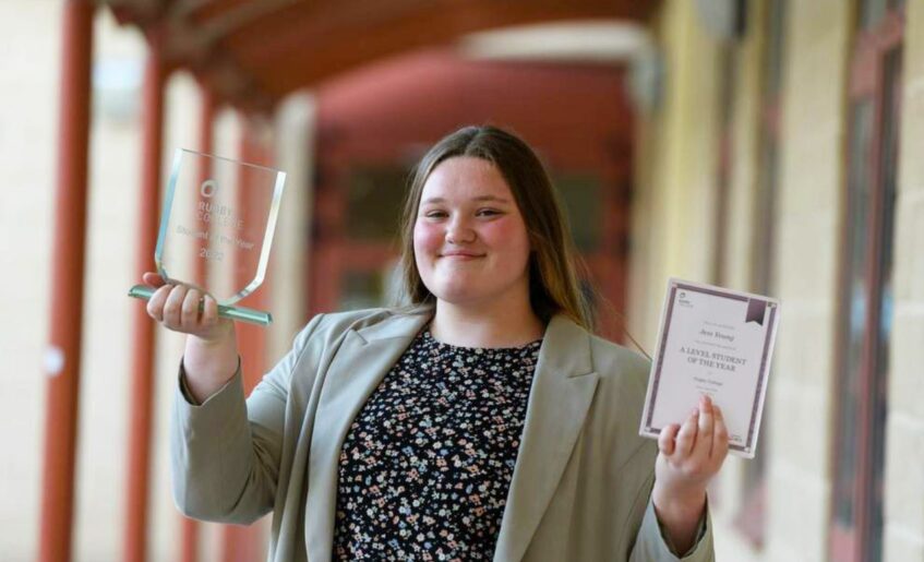 Jess Young holding her award