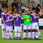 Warwick United Football team huddle