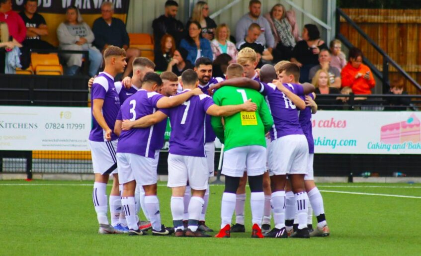 Warwick United Football team huddle