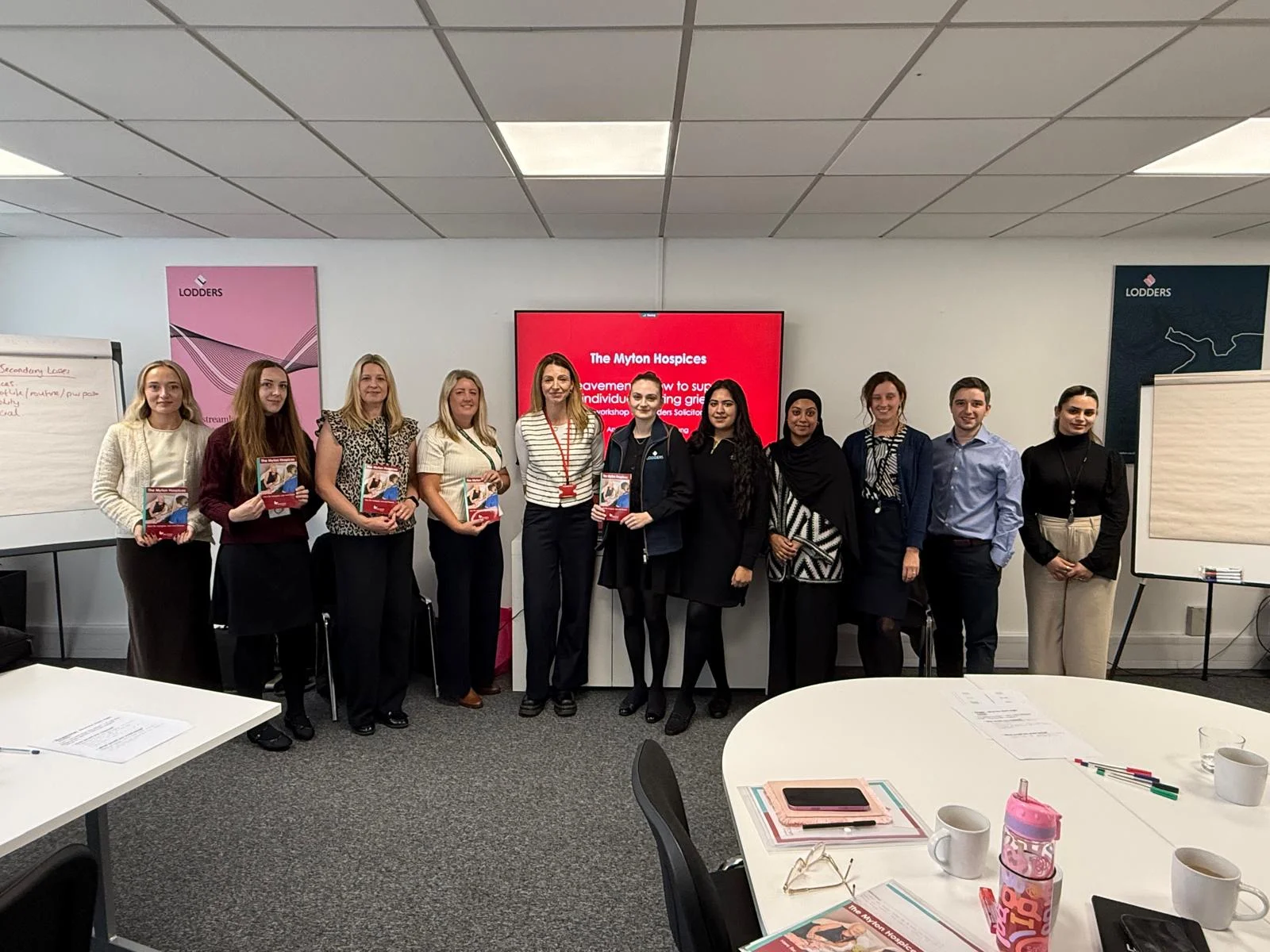 Workshop participants standing together after a Myton session