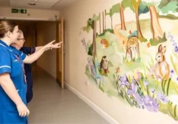 The Myton Hospices - Nurses with the mural at Coventry Myton Hospice